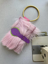 Pink furry clutch bag with handle